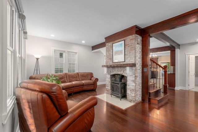 a living room with furniture a fireplace and a large window