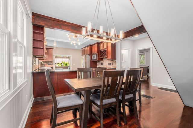 a view of a dining room with furniture and chandelier