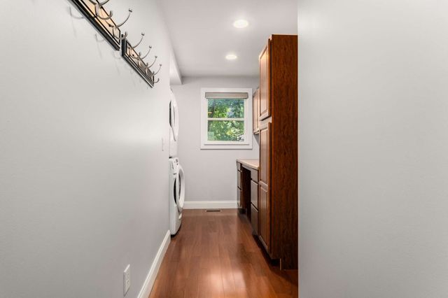 a view of hallway with wooden floor and stairs
