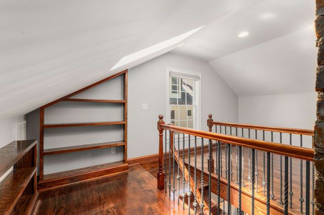 a view of staircase with white walls and a window