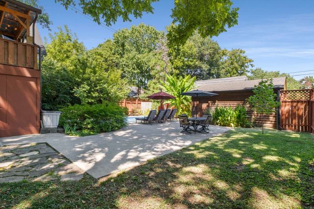 a view of a backyard with sitting area