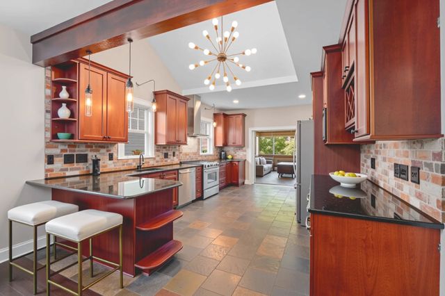 a kitchen with a table chairs stove and cabinets