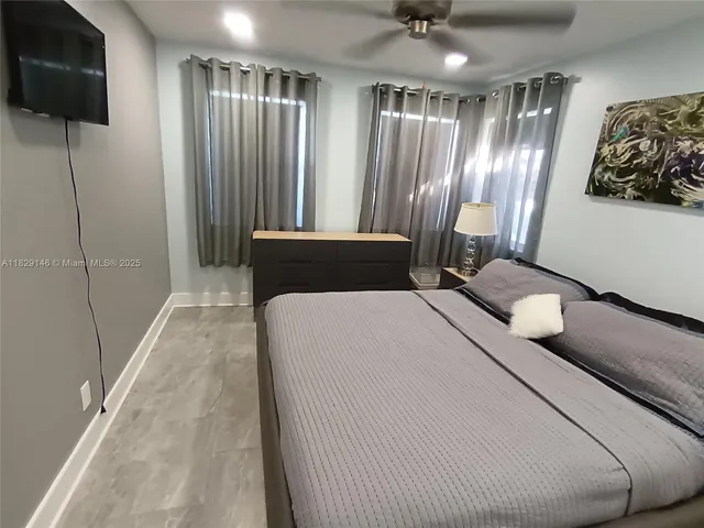 a bedroom with a bed and a mirror