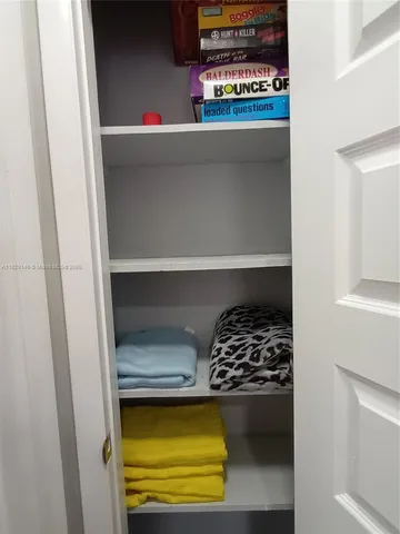 a spacious bedroom with two beds and a painting on the wall