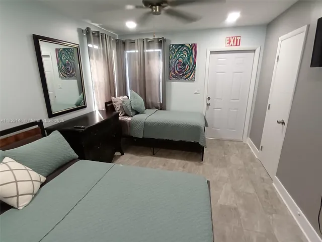 a living room with a bed furniture and a mirror