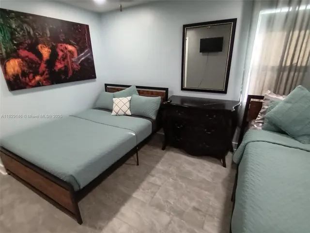 a bedroom with a bed and a mirror