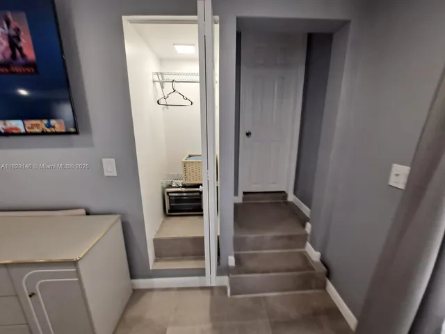 a bedroom with furniture and wooden floor