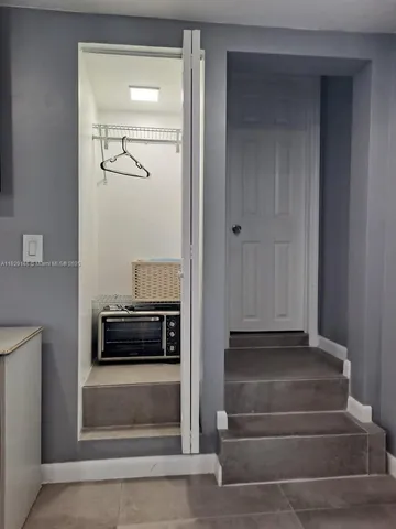 a bedroom with a bed and large mirror