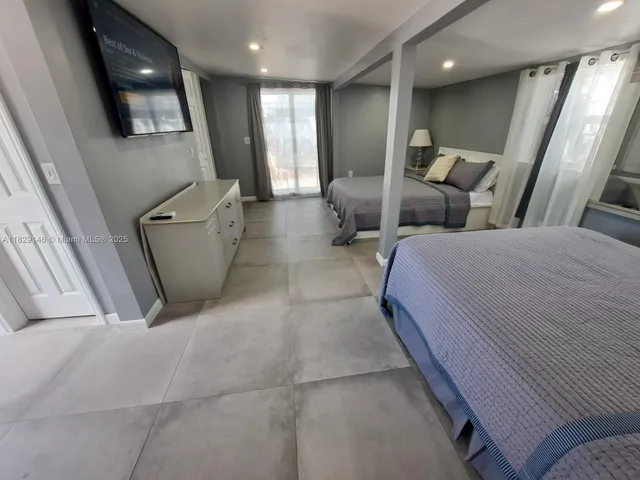 a bedroom with a bed and a flat screen television