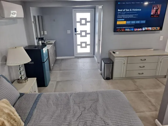 a front view of a house with a garden and plants