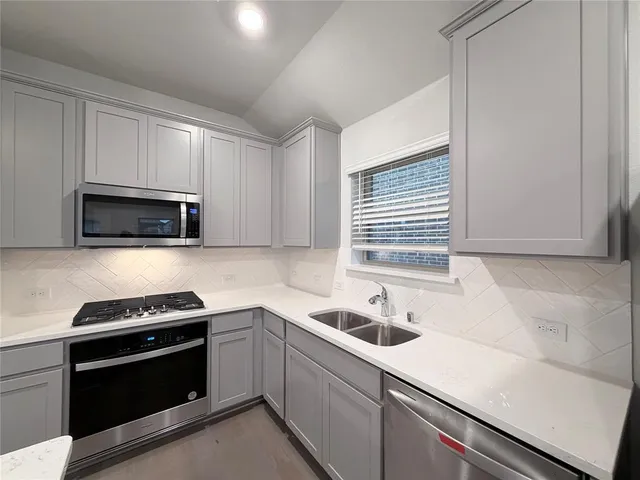 a kitchen with a sink stove and microwave