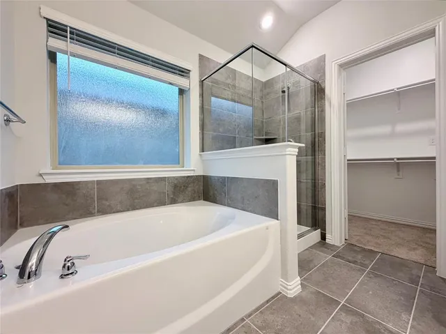 a bathroom with a tub and shower