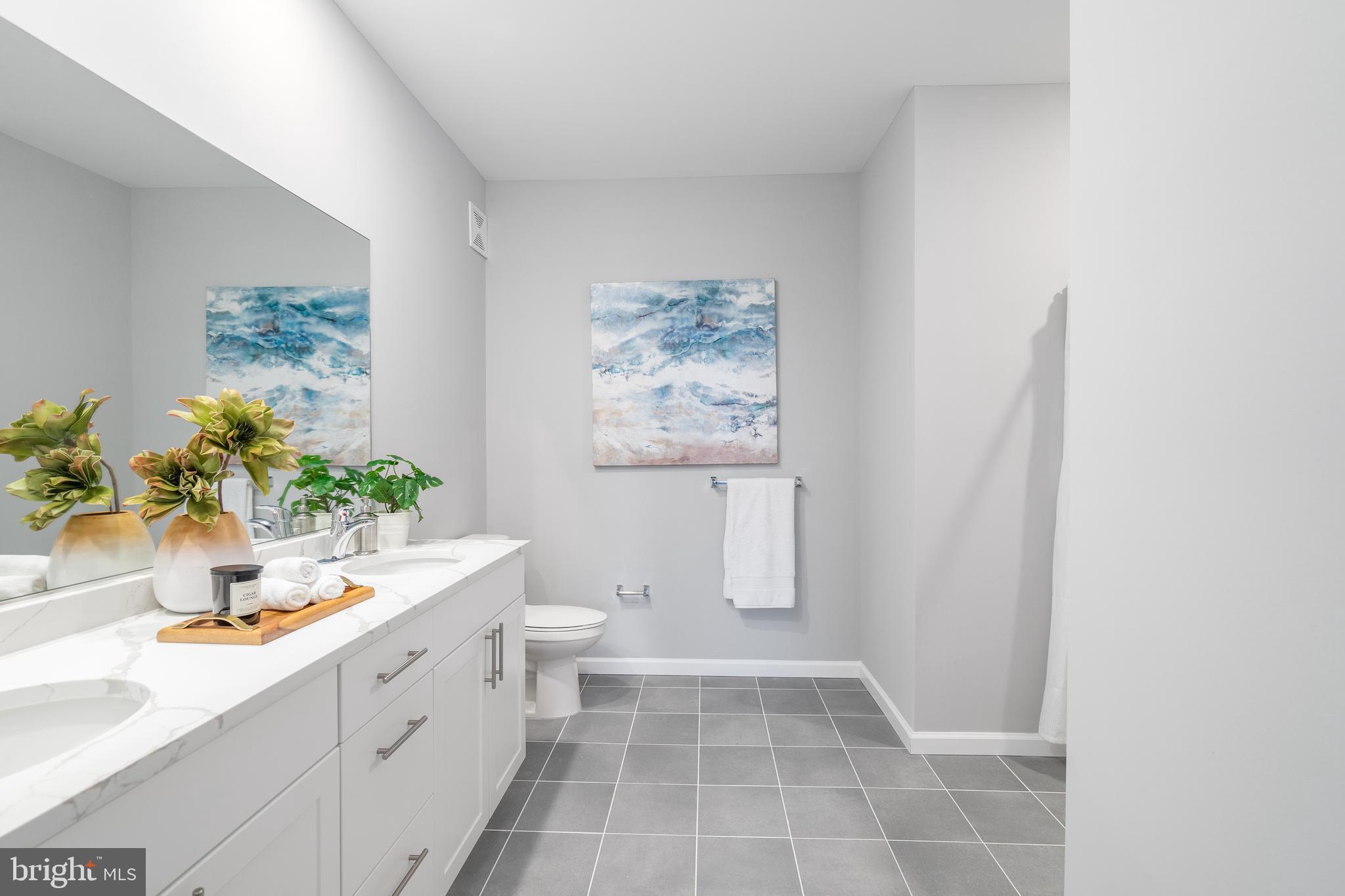 700 Citation Lane, Unit 1011 Cherry Hill, NJ 08002 - Photo 32 of 33 a bathroom with a sink a toilet and a mirror
