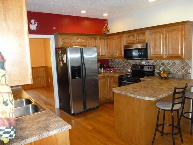 83 Rutledge Falls Road Tullahoma, TN 37388 - Photo 12 of 25 a kitchen with stainless steel appliances granite countertop a refrigerator a stove and a sink with wooden floor