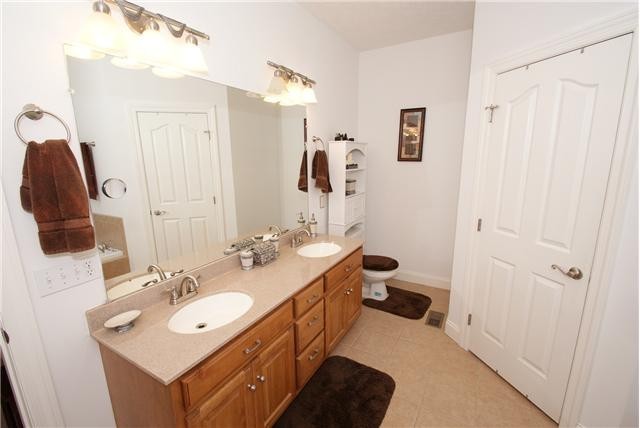 83 Rutledge Falls Road Tullahoma, TN 37388 - Photo 16 of 25 a bathroom with a double vanity sink mirror and toilet