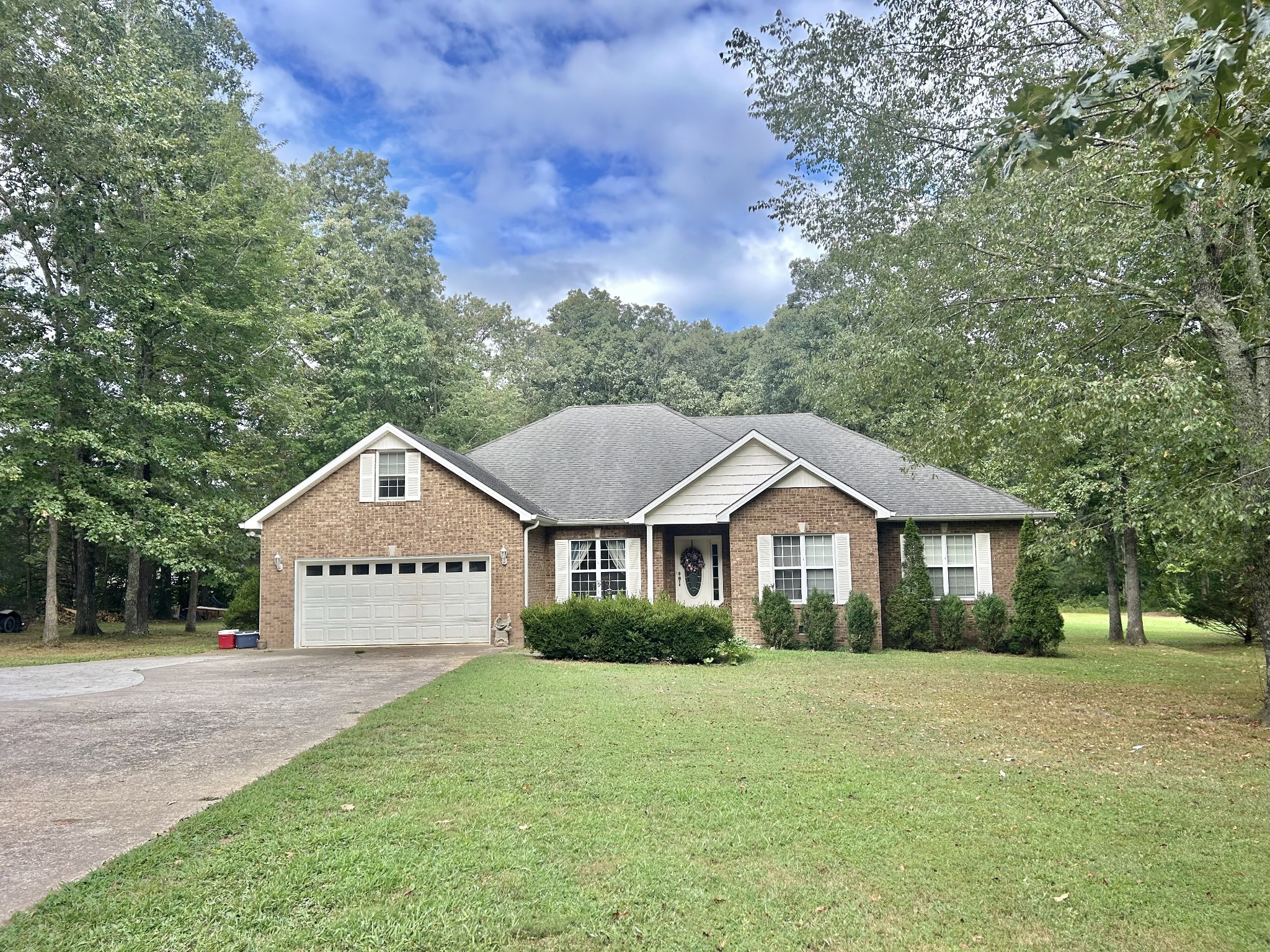 83 Rutledge Falls Road Tullahoma, TN 37388 - Photo 3 of 25 a front view of a house with a yard and trees