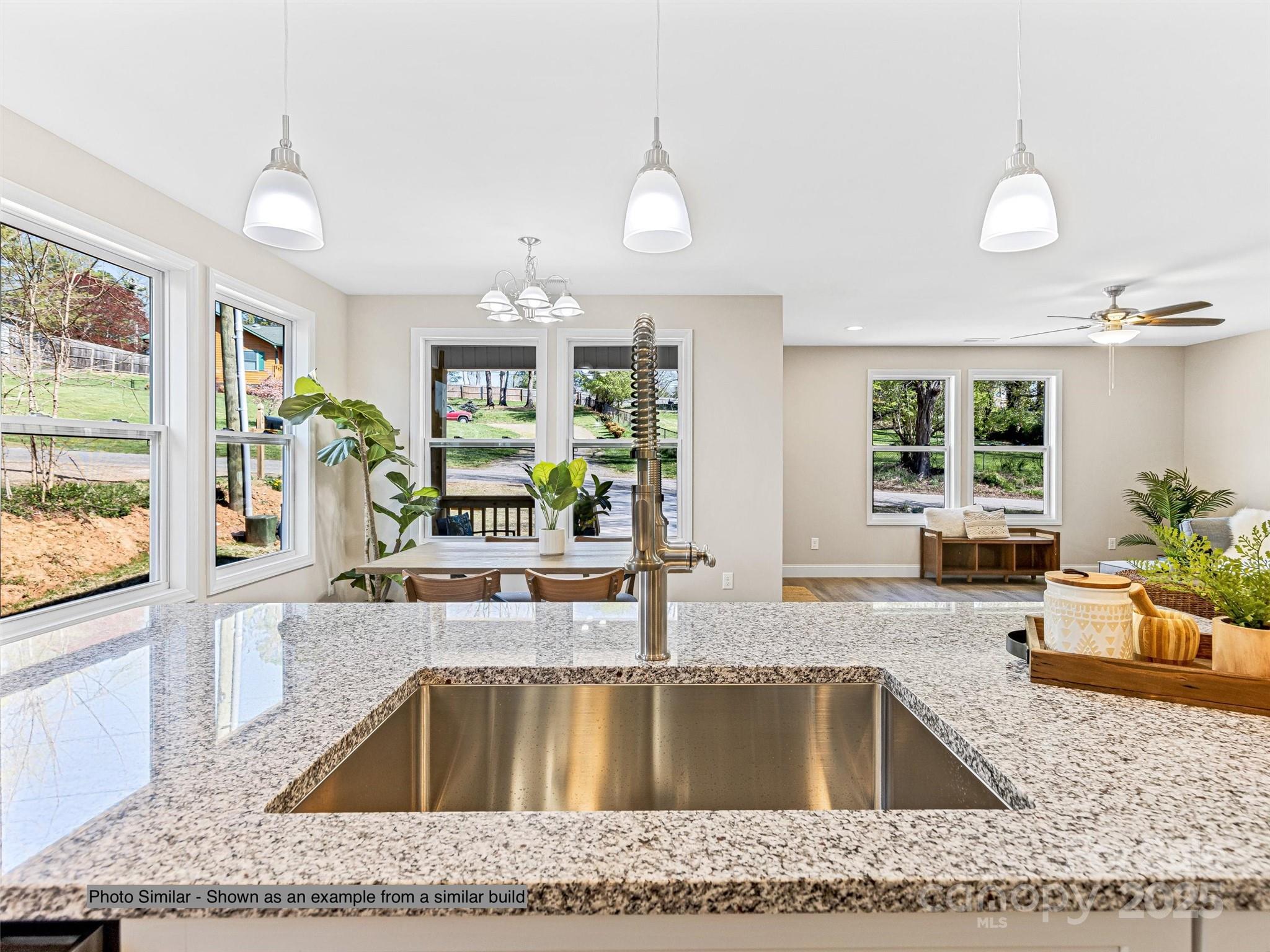 330 Peaceful Lane Clyde, NC 28721 - Photo 20 of 39 a kitchen with a granite countertop sink and natural light