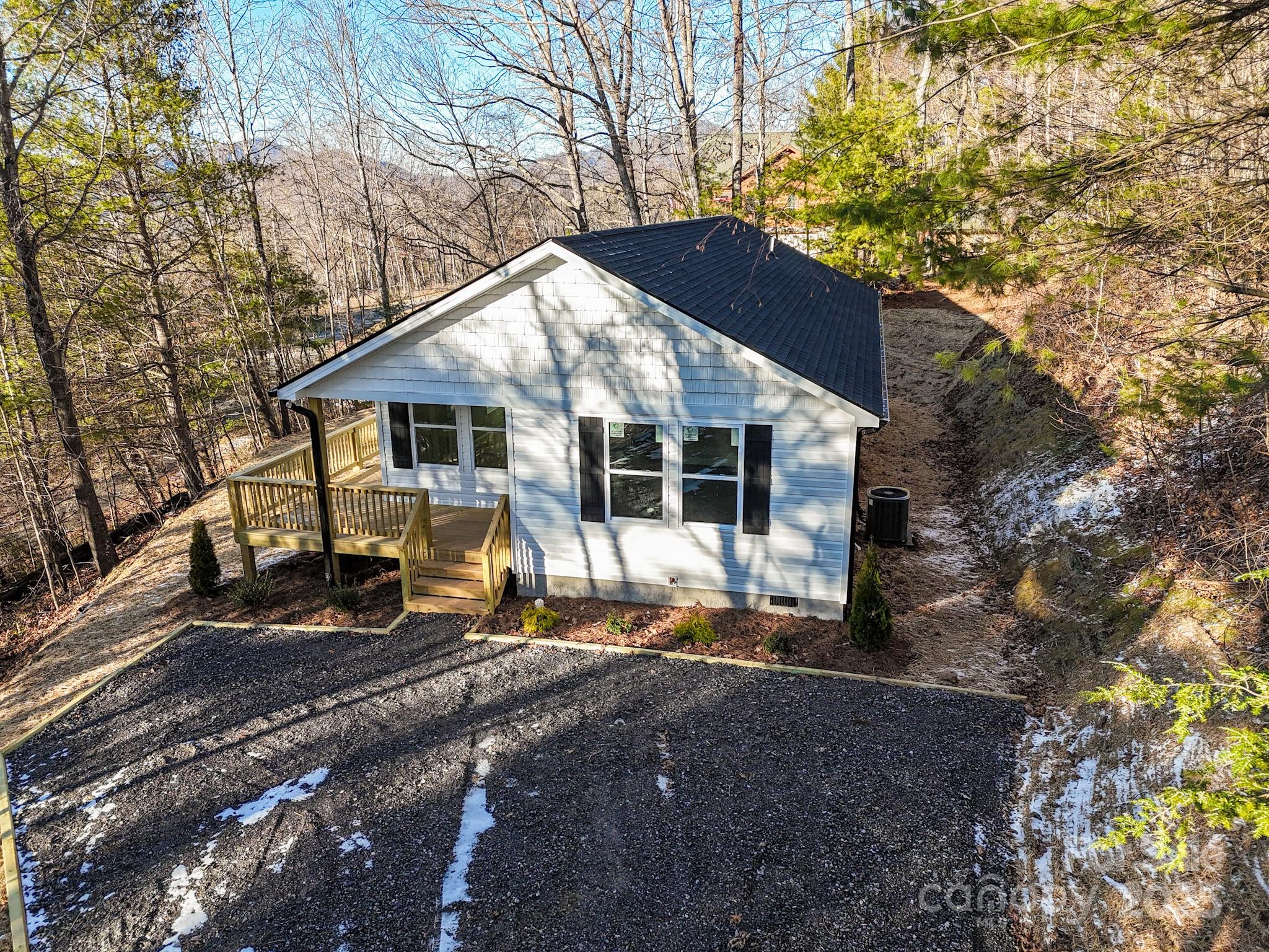330 Peaceful Lane Clyde, NC 28721 - Photo 2 of 39 a house with trees in the background