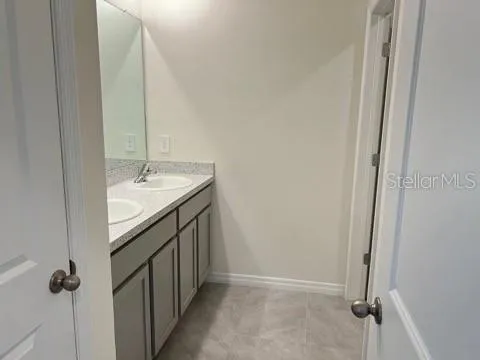 a bathroom with a double vanity sink