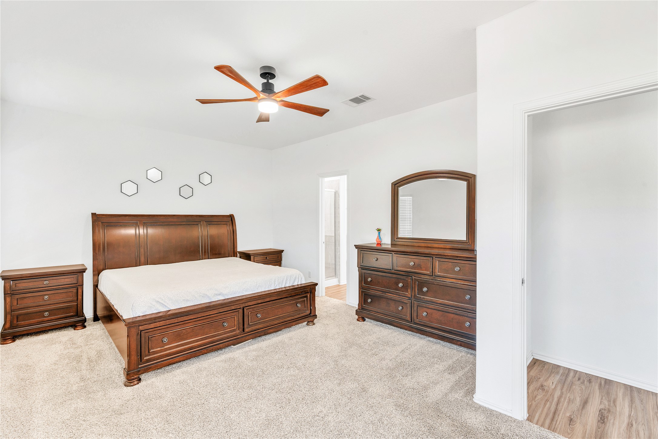 212 Saddle Mountain Road Georgetown, TX 78628 - Photo 20 of 30 A well-lit primary bedroom offers comfortable carpet flooring and a refreshing ceiling fan.