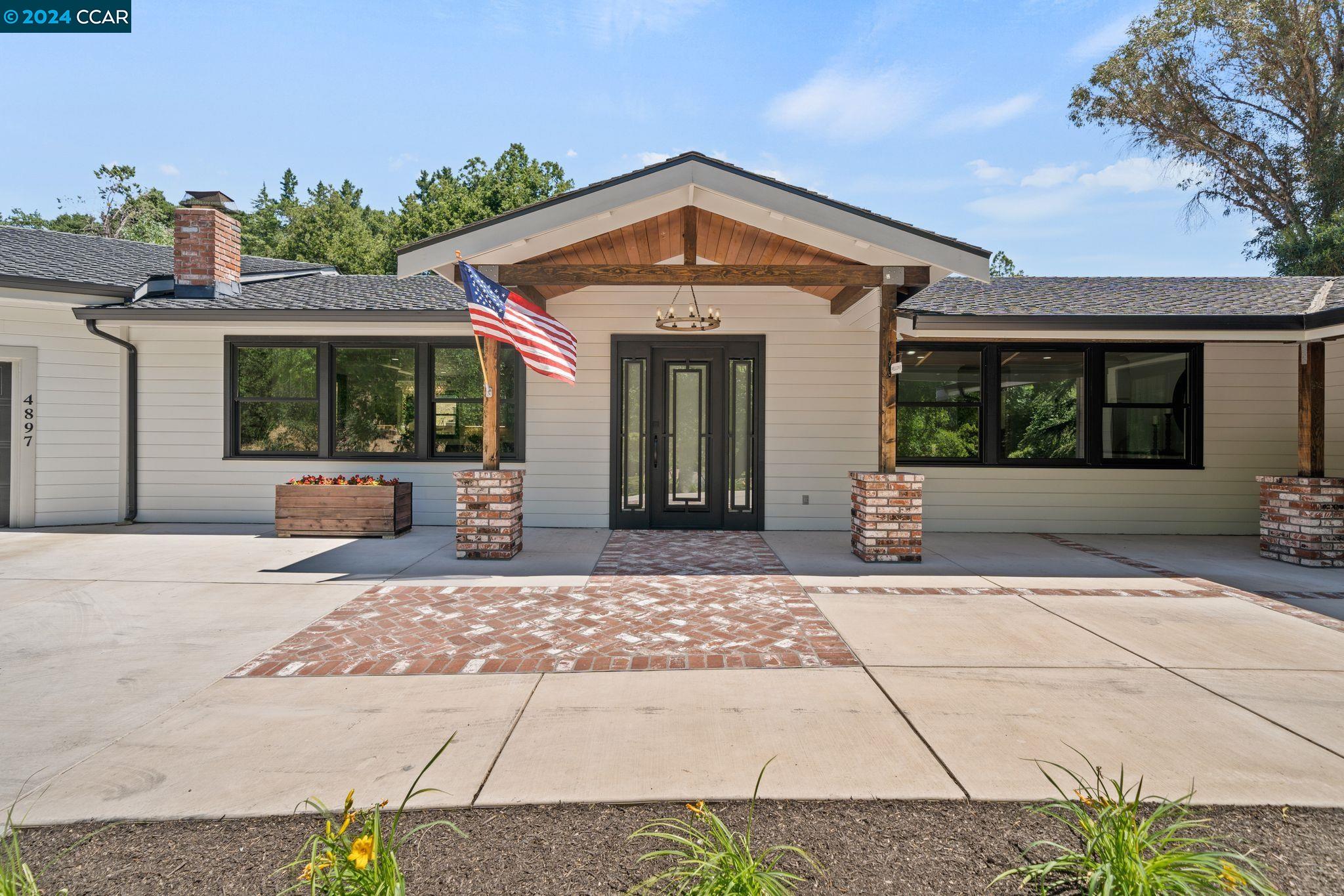 4897 John Muir Road Martinez, CA 94553 - Photo 1 of 1 a front view of a house with a yard