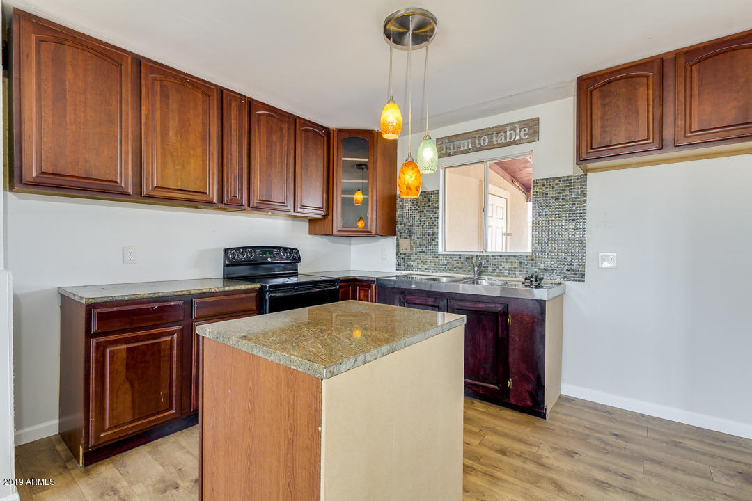 20632 West Telegram Path Road Buckeye, AZ 85326 - Photo 8 of 23 a kitchen with a sink cabinets and wooden floor
