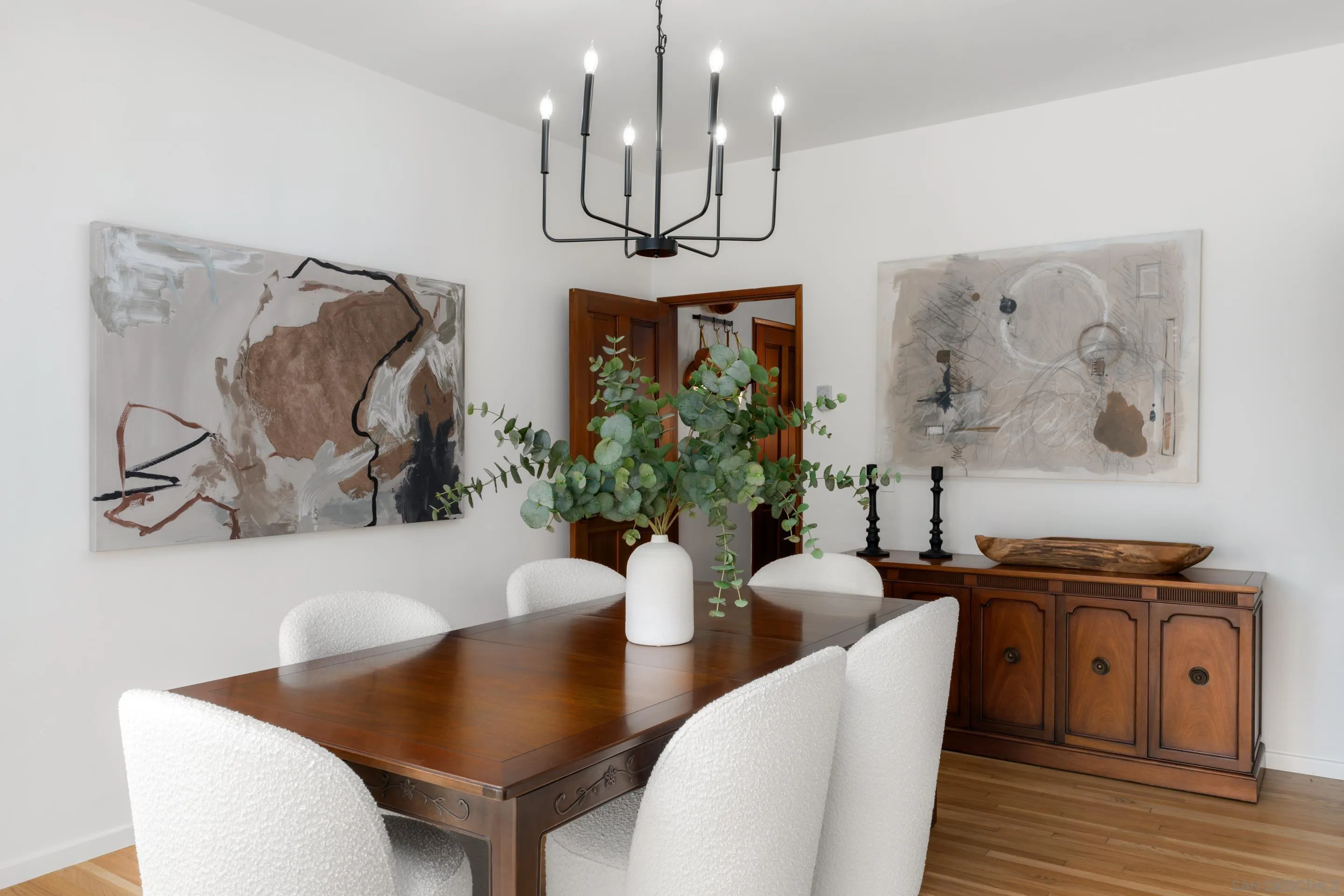 16059 Puerta Del Sol Rancho Santa Fe, CA 92067 - Photo 8 of 25 a view of a dining room with furniture wooden floor and a chandelier