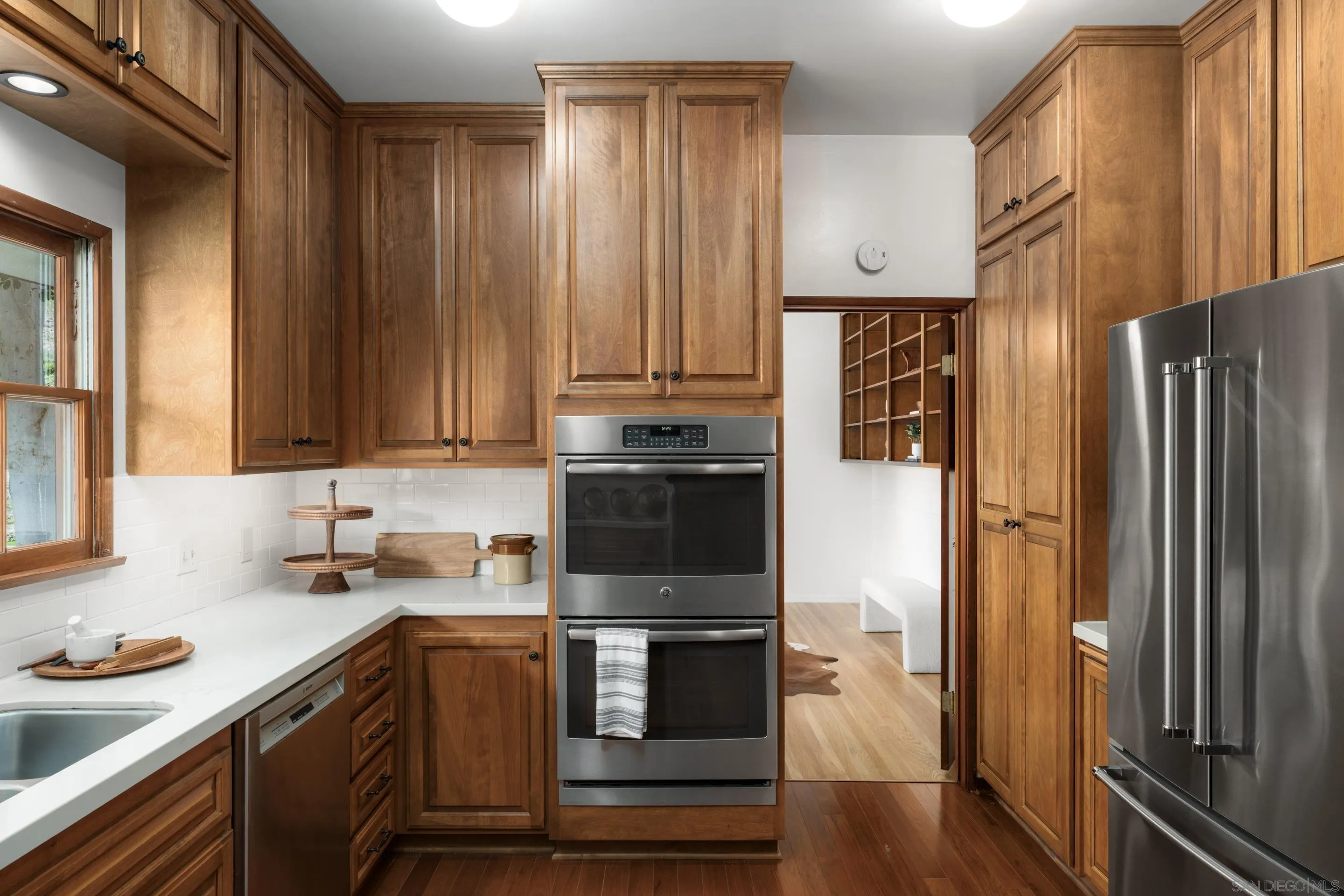 16059 Puerta Del Sol Rancho Santa Fe, CA 92067 - Photo 9 of 25 a kitchen with stainless steel appliances a refrigerator stove and sink