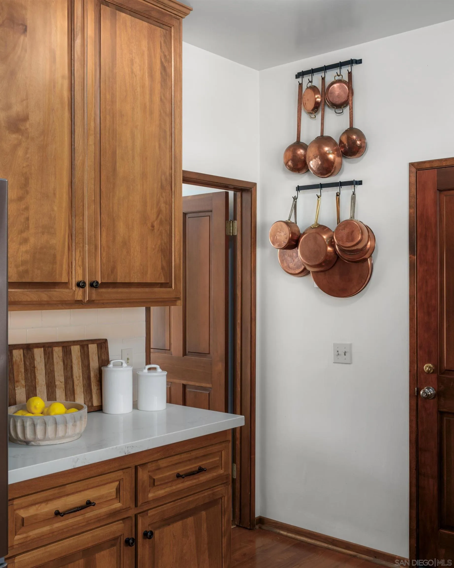 16059 Puerta Del Sol Rancho Santa Fe, CA 92067 - Photo 10 of 25 a kitchen with a refrigerator and a stove top oven