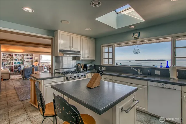 a kitchen with a sink a counter and chairs