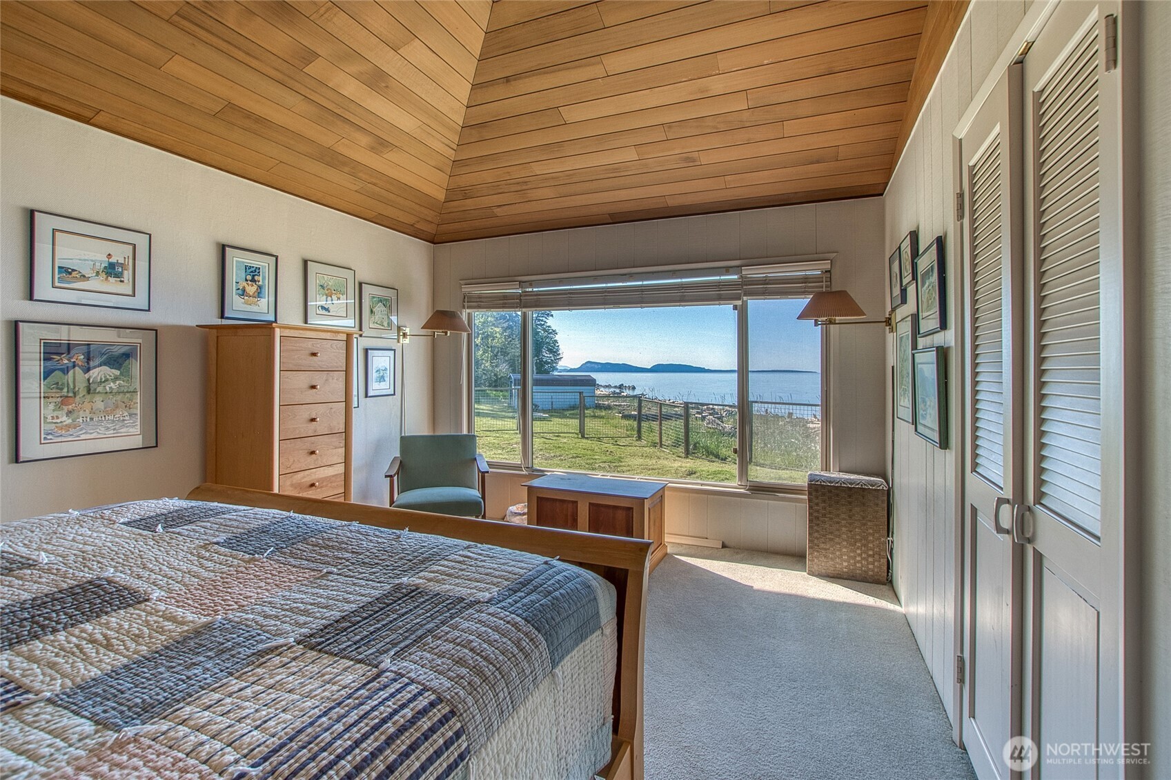 664 Tidewinds Lane Orcas Island, WA 98245 - Photo 20 of 35 a bedroom with a large bed and a large window with the outer view