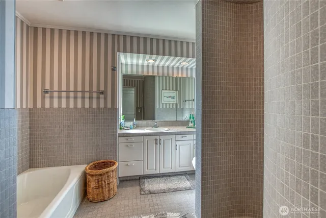 a bathroom with a tub shower and sink
