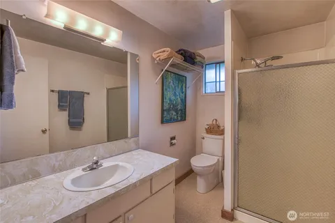 a bathroom with a sink a toilet and shower curtain