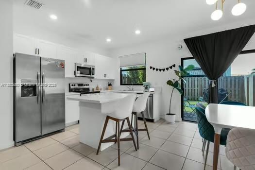 11852 Southwest 245 Terrace Homestead, FL 33032 - Photo 9 of 31 a kitchen with a table chairs refrigerator and a sink