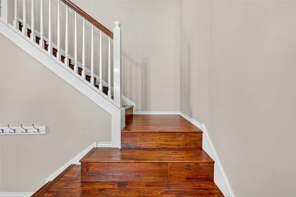 a view of entryway and hall with wooden floor