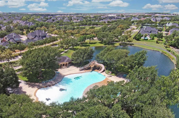 an aerial view of residential houses with outdoor space and river