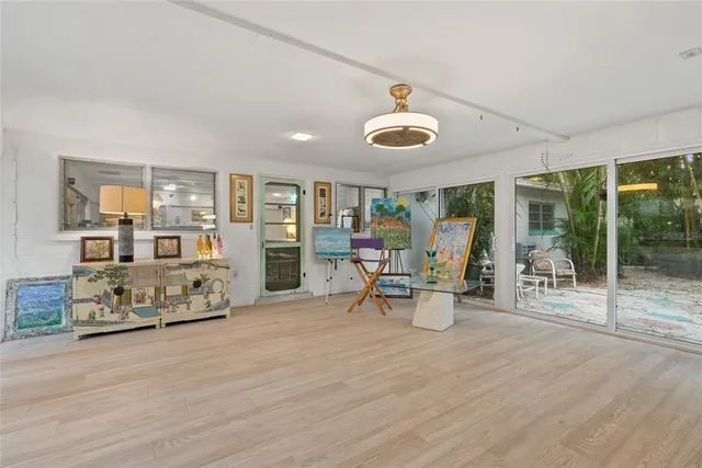 a bedroom with furniture and a large window