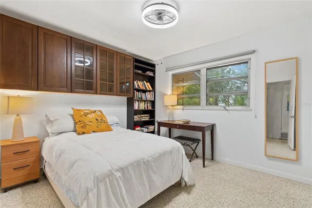 a bedroom with a bed and a window