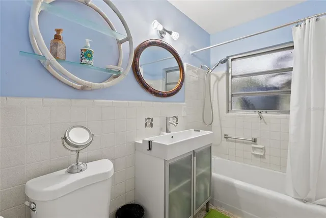 a bathroom with a toilet a sink and a mirror