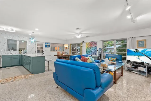 a living room with furniture and kitchen view