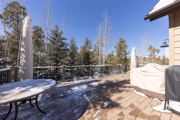 a view of backyard with a table and chairs and wooden fence