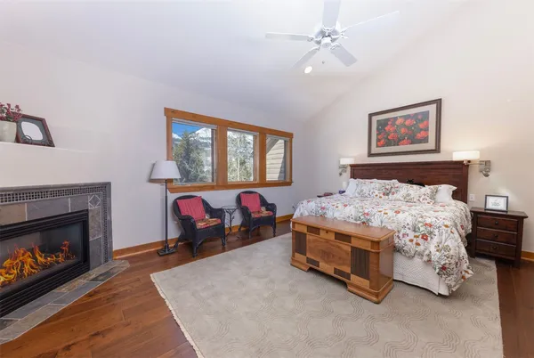 a bedroom with a bed and a fireplace