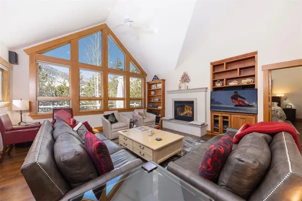 a living room with furniture fireplace and a large window
