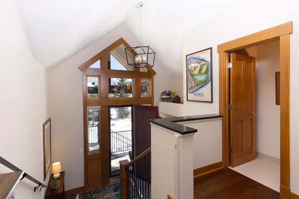 a view of hallway with cabinets and wooden floor