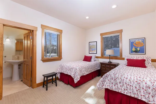 a bedroom with two beds and a table