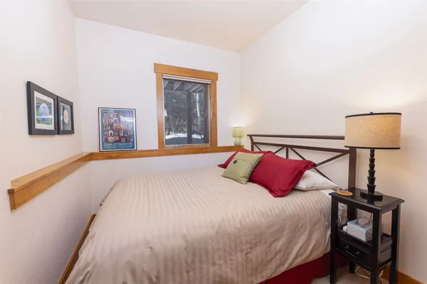 a bedroom with a bed and a lamp