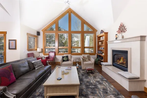 a living room with furniture large window and a fireplace