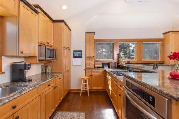 a kitchen with stainless steel appliances a sink stove and cabinets