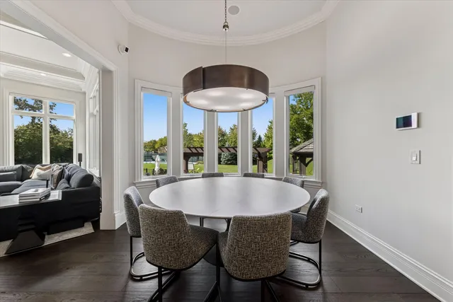 a dining room with furniture a chandelier and wooden floor