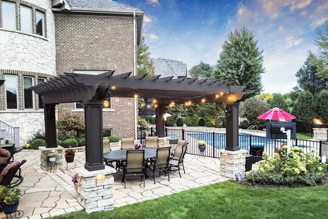 a view of a house with backyard sitting area and garden